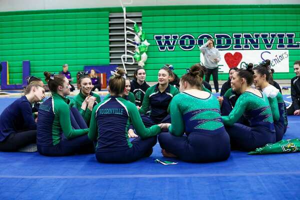 The 2023 Woodinville Lady Falcons gymnastics team limber up. Photos by Colleen Colley