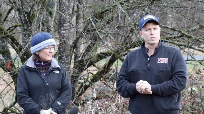 Woodinville Mayor Mike Millman and Congresswoman Suzan DelBene participate in salmon restoration on the Sammamish River on Martin Luther King, Jr. Day. Photo taken from a video by the City of Woodinville.