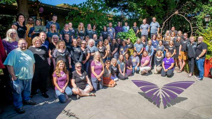 A group photo of Chrysalis staff for K-6 and 7-12 campuses.